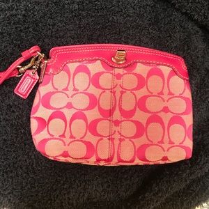 Pink Coach logo wristlet bag